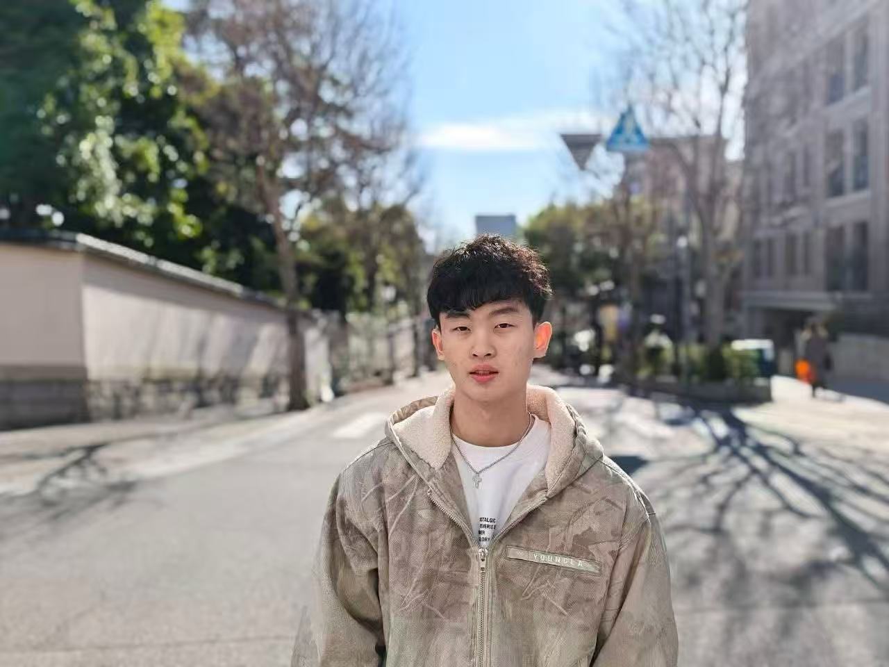 Burton Tsai standing on a sunlit street
